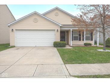 Charming single-story home featuring a well-manicured lawn, two-car garage, and a welcoming front porch at 12722 Brady Ln, Noblesville, IN 46060