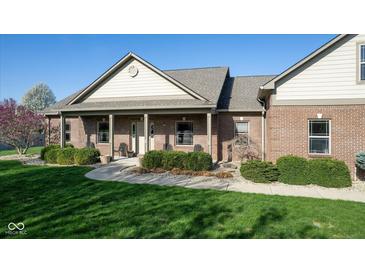 Charming brick home with well-maintained landscaping and a cozy front porch at 1484 N County Road 900 E, Avon, IN 46123