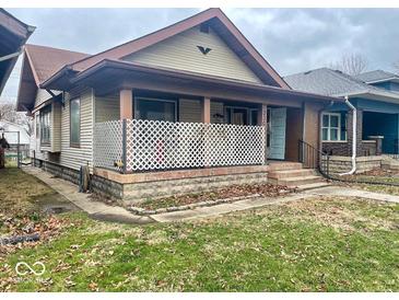 Charming home with a covered front porch and classic architectural details at 330 N Beville Ave, Indianapolis, IN 46201