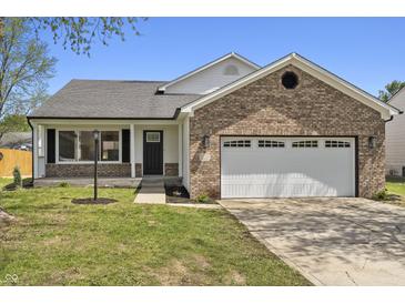 Charming single-story home featuring a brick facade and an attached two-car garage at 4057 Knollwood Ave, Franklin, IN 46131