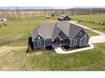 Stunning aerial view of a modern home with a well-manicured lawn and large barn on expansive acreage at 5679 S 675 W, New Palestine, IN 46163