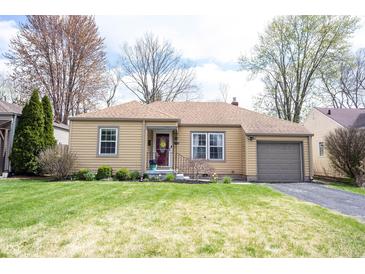 Charming ranch-style home with a well-maintained lawn, an attached garage, and inviting curb appeal at 5735 Brouse Ave, Indianapolis, IN 46220