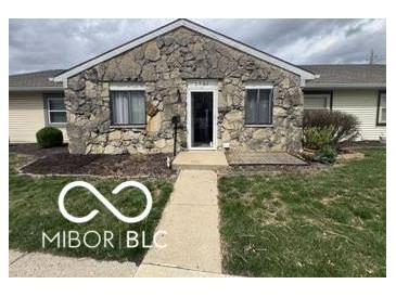 Charming single-story home with stone facade and well-maintained lawn at 2706 Country Estates Dr, Indianapolis, IN 46227