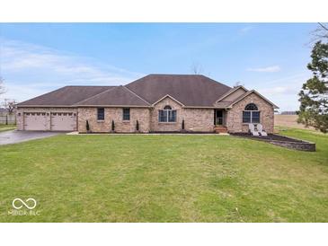 Charming brick home with a well-manicured lawn and a welcoming two-car attached garage at 4223 W State Road 234, McCordsville, IN 46055