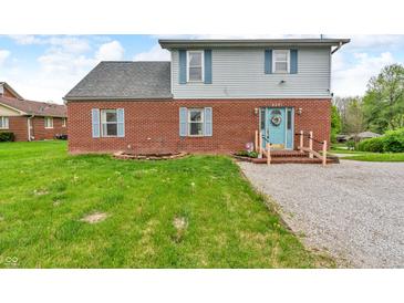 Two-story home featuring brick accents, a light blue door, and light blue shutters at 5301 Old Smith Valley Rd, Greenwood, IN 46143