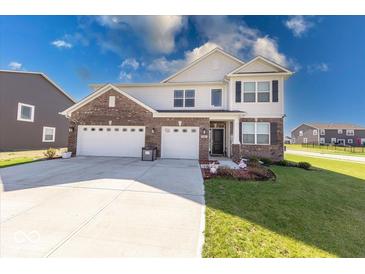 Handsome two-story home featuring brick and siding, along with a well-kept lawn at 5839 Altar Bell Cir, Greenwood, IN 46143