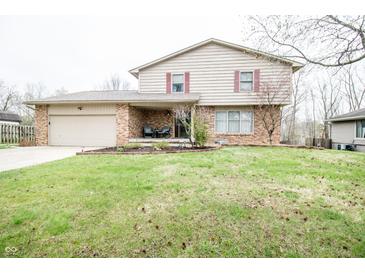Charming two-story home with a brick facade, inviting front porch, and attached garage at 632 Ridgeview Ln, Columbus, IN 47201