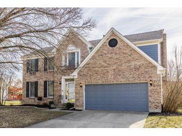 Charming two-story brick home with attached gray garage and well-maintained front yard at 8415 Anchorage Ct, Indianapolis, IN 46236