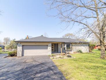 Charming single-story home featuring stone facade, attached garage and well-manicured lawn at 918 N 700 W, Greenfield, IN 46140