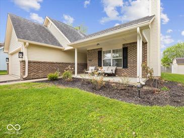 Charming brick home with a cozy front porch and manicured landscaping, perfect for relaxing outdoors at 936 Eagle Brook Cir, Shelbyville, IN 46176