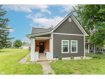 Charming two-story home featuring gray siding, well-manicured lawn, and inviting front porch at 1838 Applegate St, Indianapolis, IN 46203