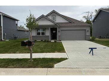 Charming single-story home with a two-car garage, manicured lawn, and a welcoming front entrance at 2199 Warbler St, Danville, IN 46122