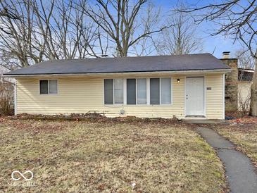 Charming single-story home with a yellow exterior, a well-maintained lawn, and a welcoming front door at 2260 N Graham Ave, Indianapolis, IN 46218