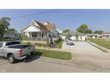 Charming white home with a welcoming front porch and ample parking space at 535 Dunn Ave, Shelbyville, IN 46176