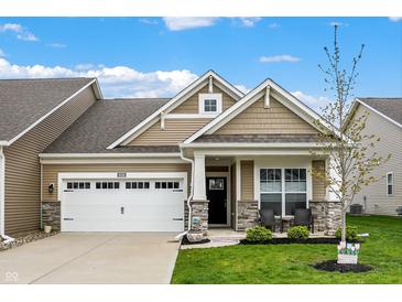 Charming single-Gathering home boasts manicured lawn, covered porch, and attached two-car garage at 6026 Rockdell Dr, Indianapolis, IN 46237