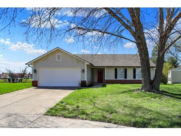 Charming single-story home featuring a two-car garage and a well-maintained front yard with mature trees at 6026 Sally Ann Cir, Indianapolis, IN 46237