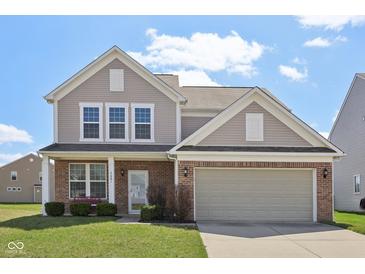 Charming two-story home with brick and vinyl siding, complemented by a well-manicured lawn at 6681 Keepsake Dr, Whitestown, IN 46075