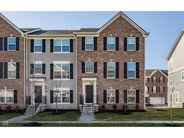 Charming townhome with brick and siding, featuring black shutters and well-manicured landscaping at 6953 Equality Blvd, Carmel, IN 46033