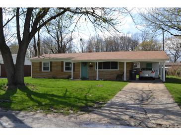 Charming ranch-style home with a quaint front yard, brick facade and a covered carport for convenient parking at 838 Highland Dr, Whiteland, IN 46184
