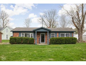 Charming brick ranch with well-maintained landscaping and inviting front porch at 89 E Walnut St, Fountaintown, IN 46130