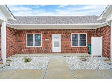 Charming brick home featuring a white front door, large windows, and stone landscaping for added curb appeal at 11975 Civic Cir, Mooresville, IN 46158