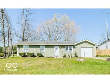 Charming single story home featuring an attached garage and a well-maintained front lawn at 12566 S Hillview Dr, Columbus, IN 47201