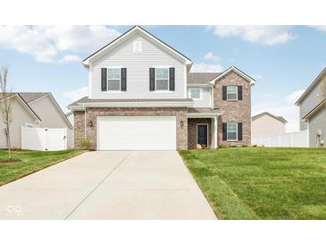 Charming two-story home featuring a brick facade and a spacious two-car garage at 1554 N Clearwater Dr, Greenfield, IN 46140