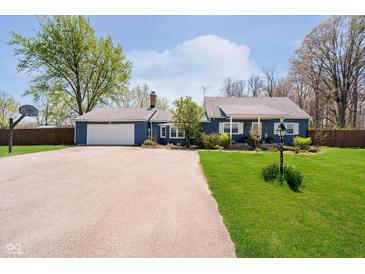 Charming blue home with a well-manicured lawn, attached garage, and a basketball hoop at 16471 E 196Th St, Noblesville, IN 46060
