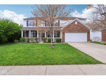 Charming two-story home with brick and siding, lush lawn, and attached two car garage at 2236 Willowview Dr, Indianapolis, IN 46239