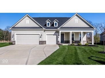 Charming home featuring a well-manicured lawn, three car garage, and inviting covered porch at 2779 Ruffian Dr, Westfield, IN 46074