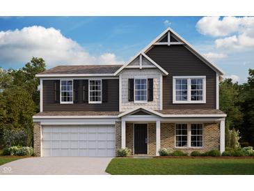 Charming two-story home featuring a brick and vinyl facade, complemented by a two-car garage and covered porch at 325 Atlas Dr, Lebanon, IN 46052