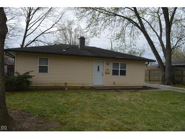 View of the front exterior of a single-story home with yellow siding and a black roof at 4431 Bertrand Rd, Indianapolis, IN 46222