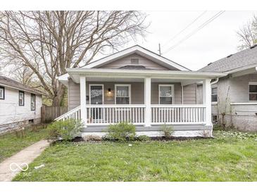Charming home featuring a quaint front porch and well-manicured lawn at 4742 Primrose Ave, Indianapolis, IN 46205