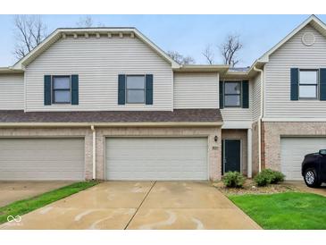 Inviting townhome featuring a brick facade, attached garage, and well-maintained landscaping at 1012 S Montgomery Rd, Greenwood, IN 46143