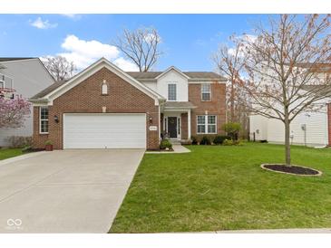 Charming brick two-story home with a well-maintained lawn and attached two car garage at 12753 Bristow Ln, Fishers, IN 46037