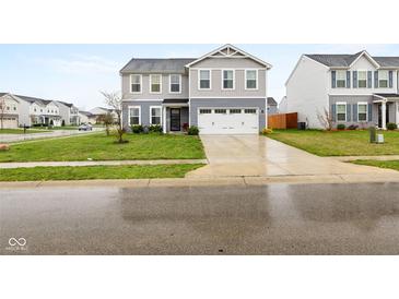 Charming two-story home featuring a two-car garage and well-manicured front lawn at 13820 N Cardonia Dr, Camby, IN 46113