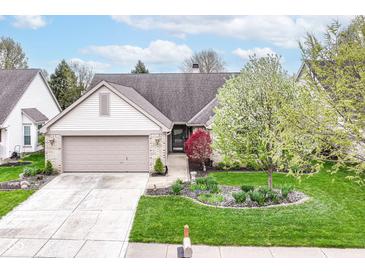 Charming single-story home featuring manicured lawn, brick facade, and attached two-car garage at 18009 Sun Ridge Cir, Noblesville, IN 46062