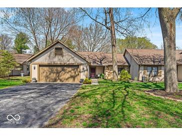 Charming single-story home featuring an attached garage and a well-maintained front yard with mature trees at 2214 Van Ness Pl, Indianapolis, IN 46240