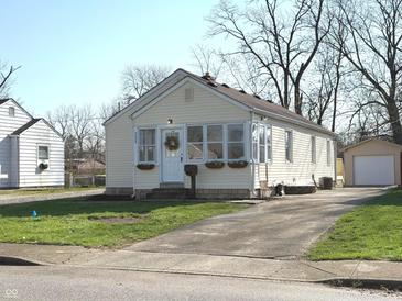 Charming home exterior featuring a wreath on the front door, cozy window planters, and a long driveway at 3233 N Tacoma Ave, Indianapolis, IN 46218