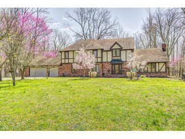Beautiful two-story home with a well-manicured lawn and mature trees, offering a serene and inviting atmosphere at 3753 Whippoorwill Lake S Dr, Monrovia, IN 46157