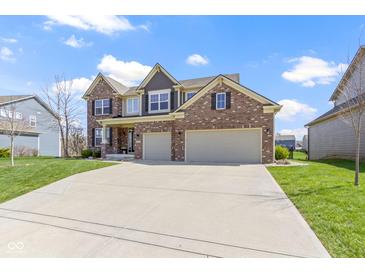 Two-story brick home with a spacious driveway and attached two-car garage at 419 Dovetree Dr, Danville, IN 46122