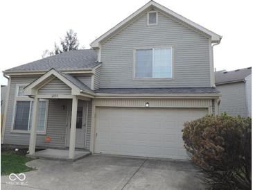 Charming two-story home with a well-manicured lawn and attached two-car garage offering curb appeal at 4959 Clarkson Dr, Indianapolis, IN 46254