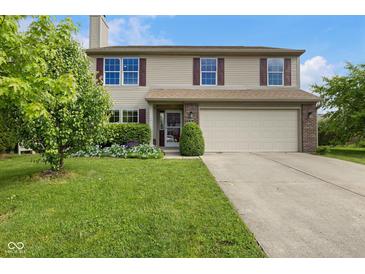 Charming two-story home with well-manicured lawn and inviting curb appeal showcasing the welcoming facade at 518 Carthage Cir, Westfield, IN 46074