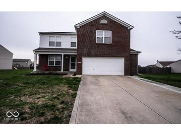Charming two-story home with a brick facade and attached two-car garage, complemented by a well-maintained lawn at 729 Stonehenge Way, Brownsburg, IN 46112