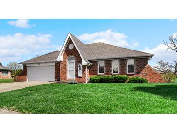 Charming single-Gathering home featuring a brick facade, attached garage and well-maintained lawn at 803 S School St, Brownsburg, IN 46112
