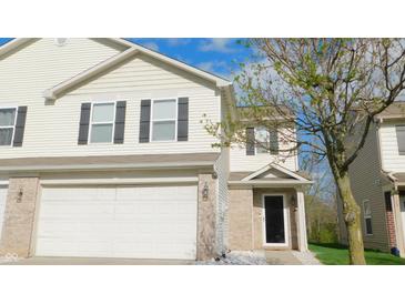 Charming townhome showcasing neutral siding, dark shutters, and an attached garage at 1139 Topp Creek Dr, Indianapolis, IN 46214
