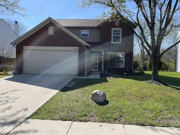 Charming two-story home with a brick facade, attached garage, and well-maintained lawn at 13660 N Ayrshire Cir, Camby, IN 46113