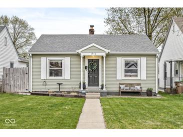 Charming one-story home with a well-manicured lawn, and a welcoming front door and entryway at 1741 Caldwell Pl, Columbus, IN 47201