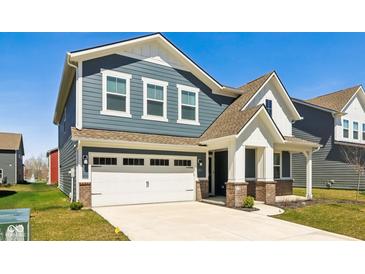 Charming two-story home with blue siding, white garage door, and brick accents, complete with a well-maintained lawn at 2250 Egbert Rd, Westfield, IN 46074