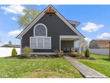 Charming home with a well-manicured lawn, a welcoming porch, and a unique architectural design at 3015 S Rybolt Ave, Indianapolis, IN 46241